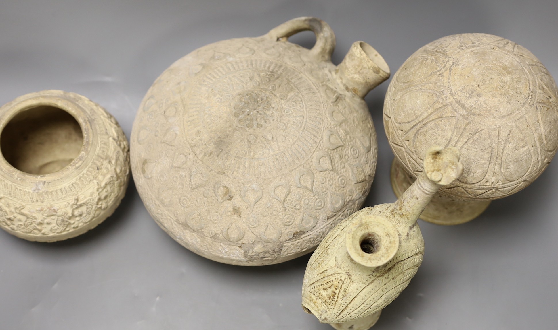 A selection of four Islamic terracotta vessels, Middle Eastern possibly 12th century, the animal headed ewer 22 cm high